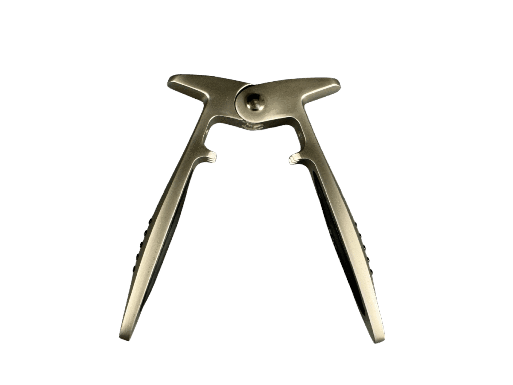 Close-up of a metal champagne bottle opener and cork gripper